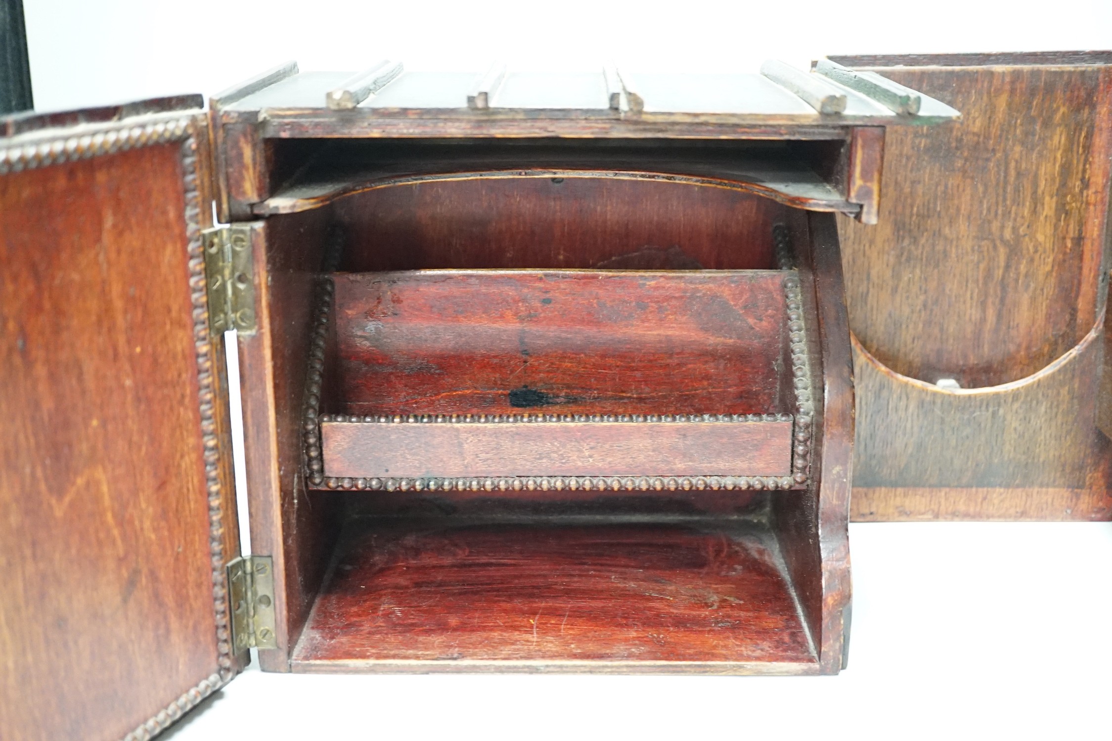 An early 20th century painted carved oak novelty stationary box modelled as books, 27cm wide, 23cm tall, 16cm deep